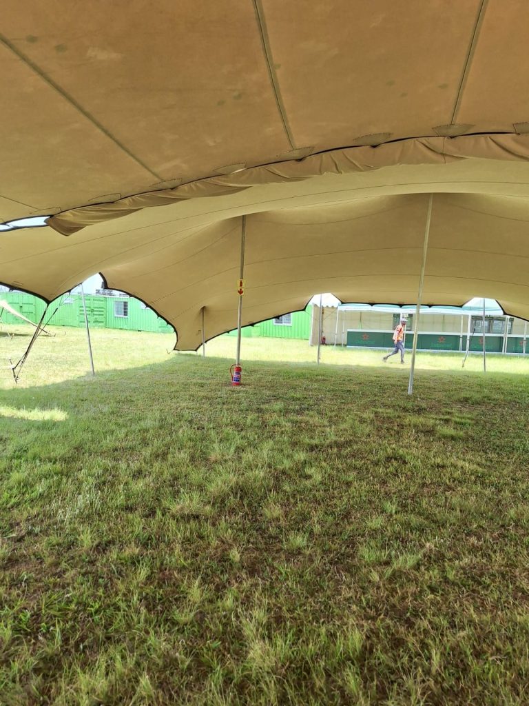 Explore South Africa's Finest Stretchy Tents with Me! 3 Events Guys A stretchy tent under a grassy field.